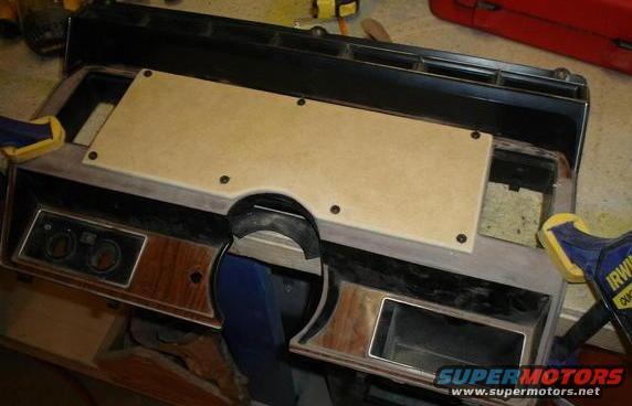 Custom dashboard panel with wood grain trim and two circular gauges