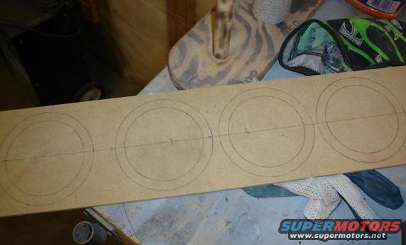 MDF board with four circles drawn for speaker mounting