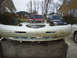 1996 Ford Thunderbird - A detached front bumper is shown in the foreground, with other vehicles visible in the background.