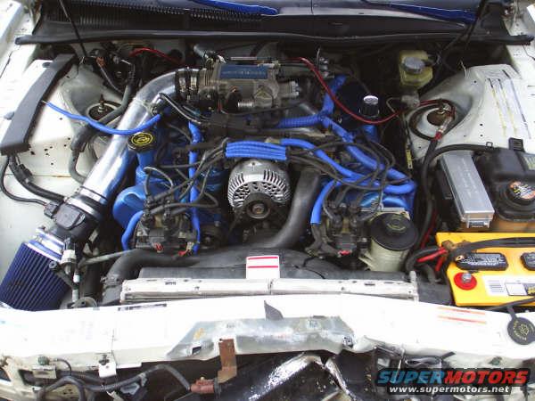1996 Ford Thunderbird engine bay with blue hoses and aftermarket air intake