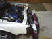 1996 Ford Thunderbird - Damaged 1996 Ford Thunderbird shows its engine bay and front-end collision damage.