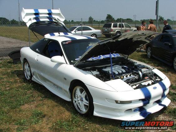 White 1993 Ford Probe with blue stripes, hood and trunk open, showing engine