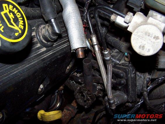 Same FUBAR setup at the other end of the tube.  The joints were ground and looked like they might have been fluxed . . . in other words the guy was in the process of mocking it up and prepping it for welding, but never finished and left it hooked up with heater hose and clamps over the two joints.