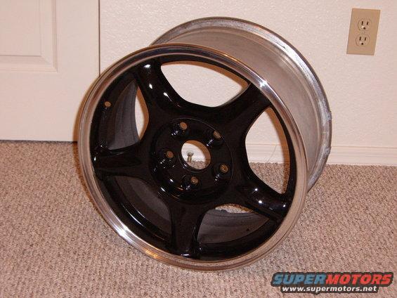 Black five-spoke alloy wheel with polished lip