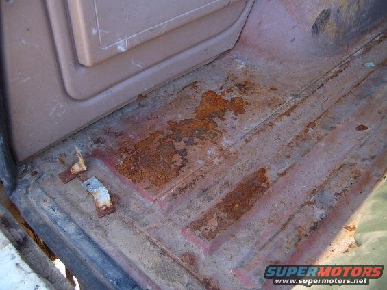 Rusted interior floor with brown paneling