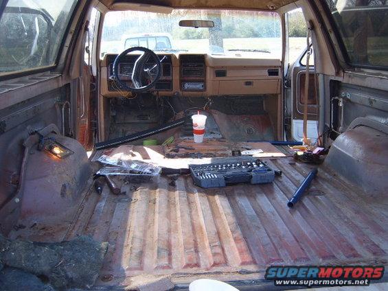 1988 Ford Bronco interior with tools and disassembled parts