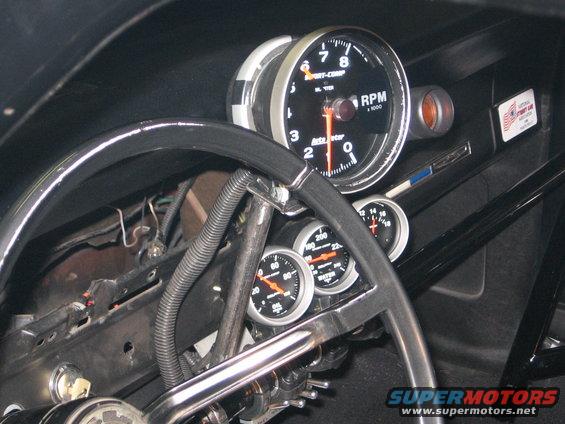 Interior gauges and steering wheel with tachometer, oil pressure, and water temperature gauges