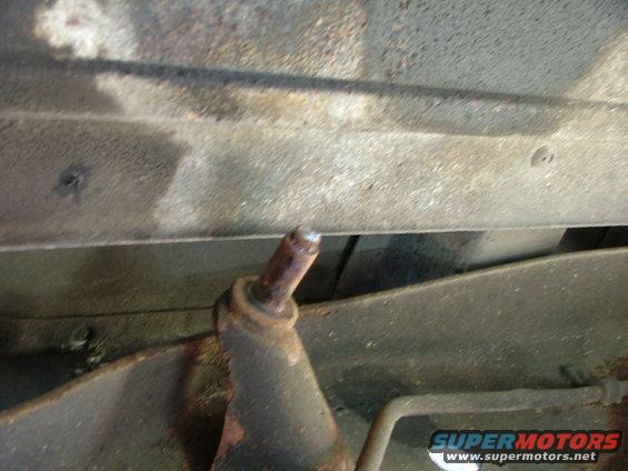 Close-up of a broken mount on the underside of a vehicle frame