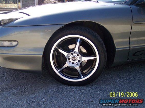 1995 Ford Probe front wheel with aftermarket rims and fender detail