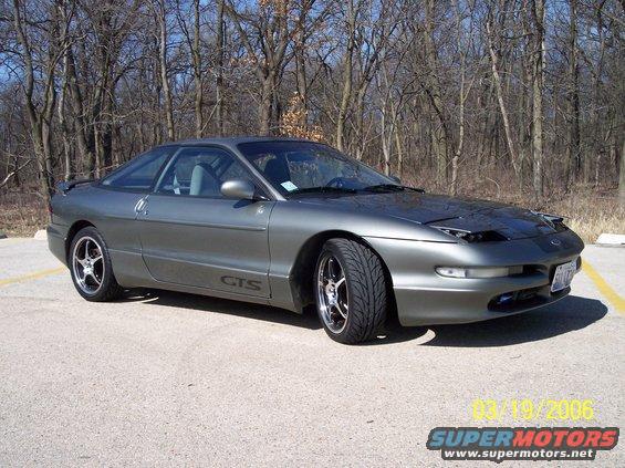 Gray 1995 Ford Probe coupe with aftermarket rims and 'GTS' decal on the side