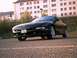 1994 Ford Probe - A black coupe is parked on asphalt in front of a building.
