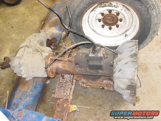 Vehicle transmission and differential assembly with a tire and wheel in the background