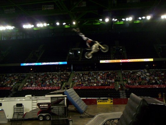 Motocross rider mid-air jump over stadium crowd