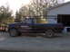 1995 Ford F-250 - This 1995 Ford F-250 pickup truck is seen from the side, equipped with a rack and a plow attachment.