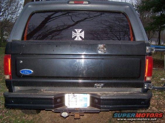 Black 1992 Ford Bronco rear with a camper shell and a 'Choppers' sticker on the window