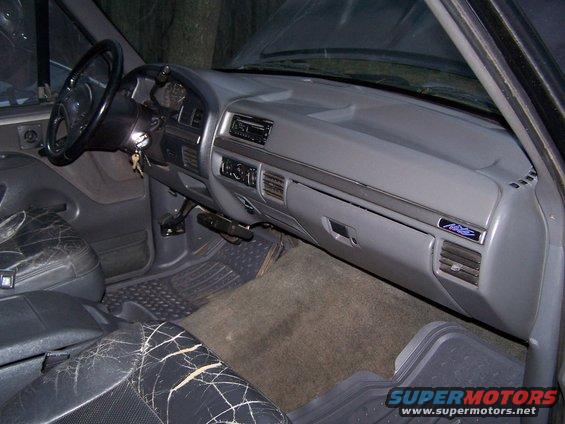1992 Ford Bronco interior with cracked leather seats and dashboard