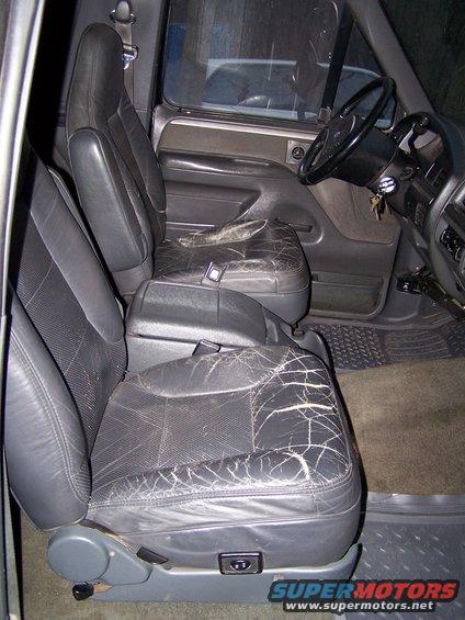 Interior of a 1992 Ford Bronco showing cracked leather front seats and dashboard