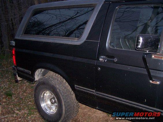 1992 Ford Bronco, side view, black paint, aftermarket wheels
