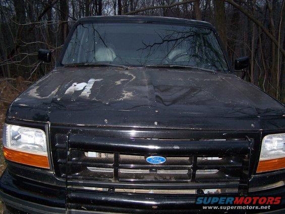 Black 1992 Ford Bronco front view, hood paint peeling, grille intact