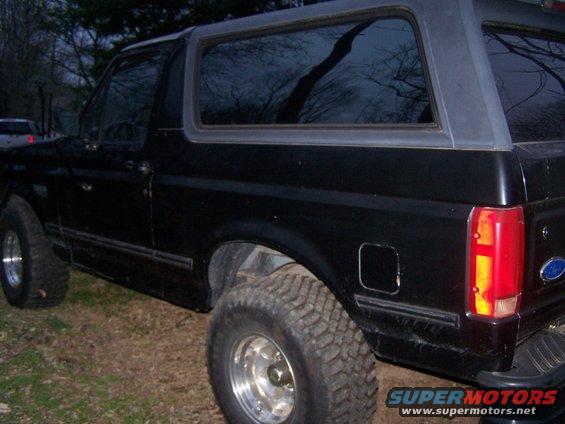 1992 Ford Bronco side view, black exterior, aftermarket wheels