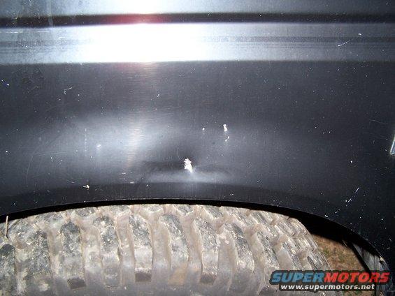 Dent on front driver side fender.