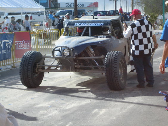 Off-road buggy with BFGoodrich tires and windshield banner, front view