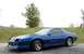 1990 Chevrolet Camaro - A blue Chevrolet Camaro IROC-Z is seen from a three-quarter front angle, parked outdoors.