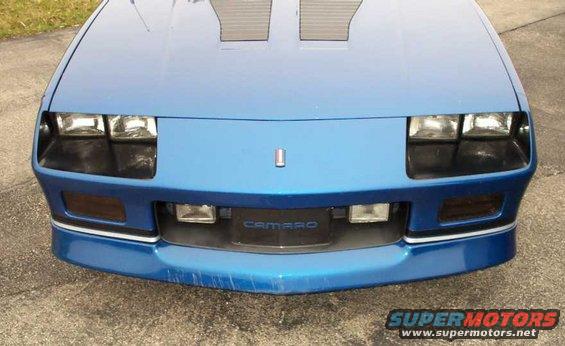 Blue 1990 Chevrolet Camaro front end with pop-up headlights and 'CAMARO' grille emblem