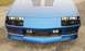 1990 Chevrolet Camaro - Front view of a blue 1990 Chevrolet Camaro, showing its distinctive grille and headlight design.
