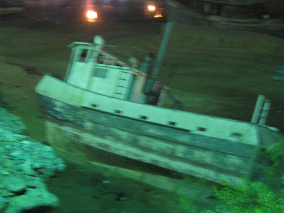 Boat grounded in shallow water at night