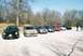 2004 Dodge SRT-4 - A group of cars are lined up in a parking lot on a clear day with bare trees.