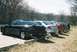 2004 Dodge SRT-4 - A line of sedans, including a black Grand Am and a silver Neon, are parked in a lot.