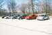 2004 Dodge SRT-4 - A group of Dodge Neons are lined up in a parking lot with trees in the background.