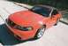 2004 Dodge SRT-4 - This red convertible sports car has a black soft top and distinctive hood scoops.