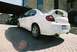 2004 Dodge SRT-4 - Rear view of a white 2004 Dodge Neon SRT-4, showing its distinctive spoiler and dual exhaust pipes.