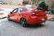 2004 Dodge SRT-4 - Rear view of a red 2004 Dodge SRT-4 with a prominent spoiler and aftermarket wheels.