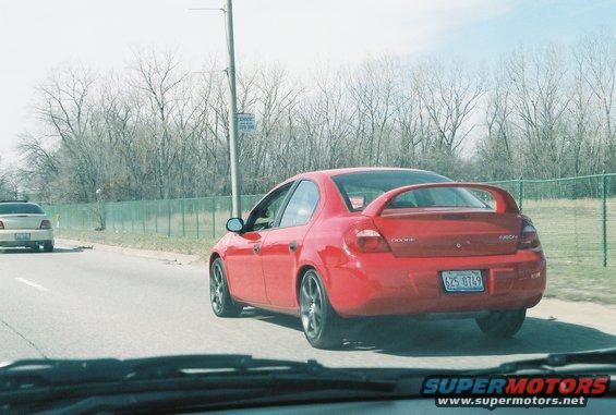 Red 2004 Dodge SRT-4 rear view with spoiler and license plate 6Z5 0749