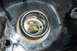 1994 Ford F-150 - The fuel filler neck of a vehicle shows some wear and tear around the opening.
