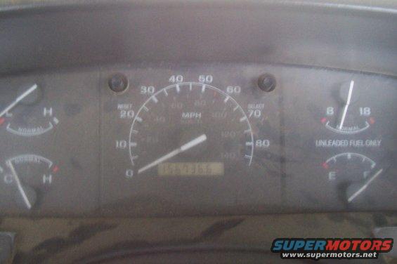 Dashboard gauges with speedometer, fuel gauge, and temperature gauges. Odometer reads 156735
