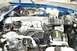 1990 Chevrolet Camaro - Close-up view of the engine bay of a blue Chevrolet Camaro, showing the V8 engine components.