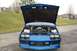 1990 Chevrolet Camaro - A blue Chevrolet Camaro is parked outside with its hood open, revealing the engine compartment.