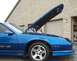 1990 Chevrolet Camaro - The blue Chevrolet Camaro IROC-Z has its hood open, revealing the engine bay.