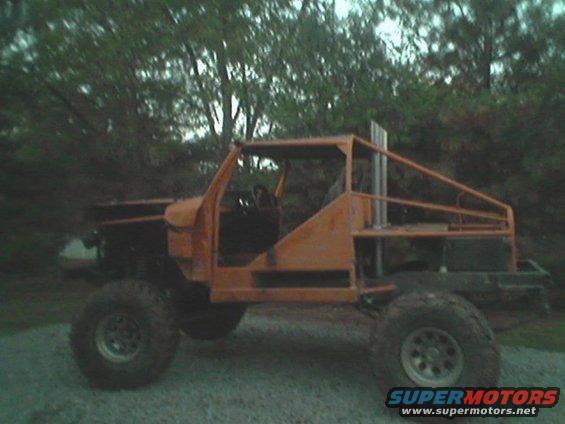 custom off-road vehicle with roll cage and tall exhaust pipe, side view