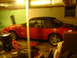 1986 Ford Mustang - Red convertible, likely a 1987 Ford Mustang, parked indoors with the top down.