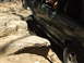 1996 Ford Bronco - Off-road vehicle navigating challenging rocky terrain on a trail.