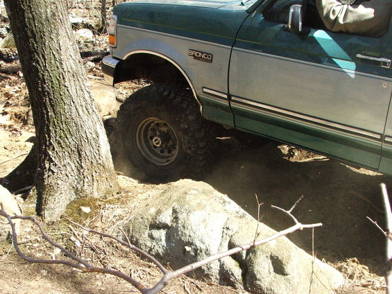 Green and silver 1996 Ford Bronco navigating rocky terrain