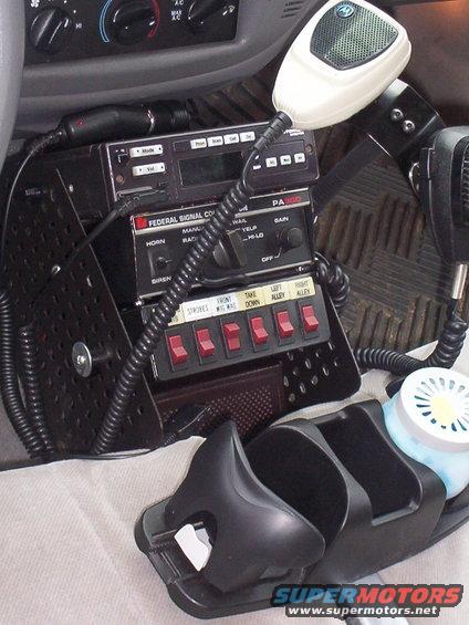 Vehicle interior with police radio, siren controls, and two microphones