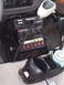 2002 Ford Crown Victoria - Close-up of a police vehicle's interior, showing communication and control equipment.