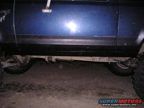 Blue 1986 Ford Bronco II side panel with visible 'Bronco II' badge and undercarriage
