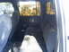 1985 Ford Bronco - View of the rear seating area and interior door panel of a vehicle.